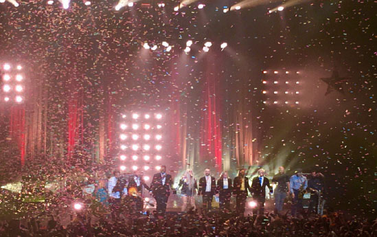The crowd cheers as the confetti rains down on some of the performers during Keshas live concert