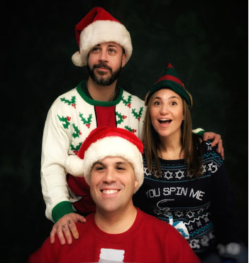 Kunz (bottom), Sena (left), and Turner (right) pose for their holiday-themed ugly sweater picture