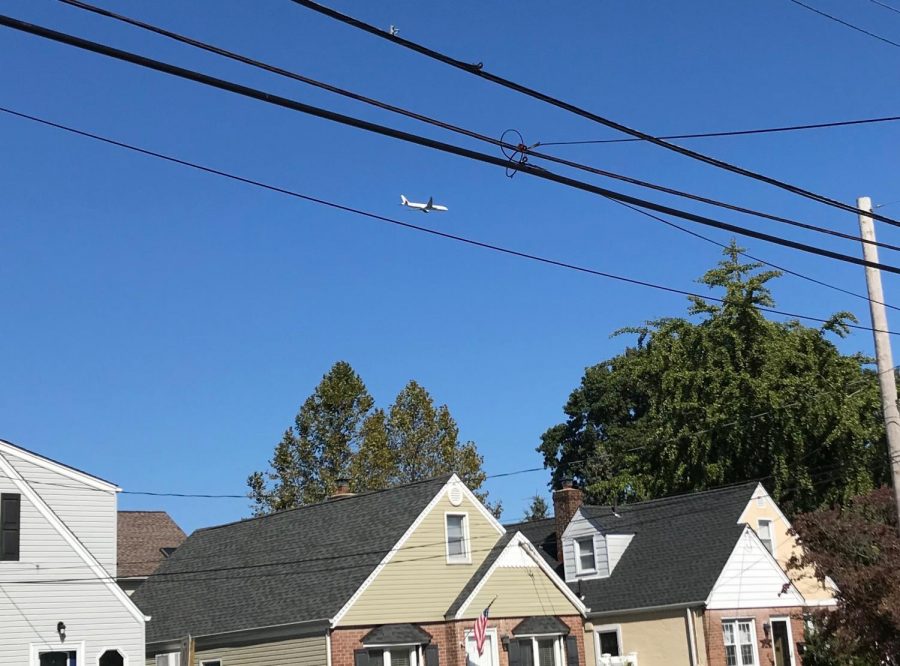 A low-flying plane flying over Lynbrook