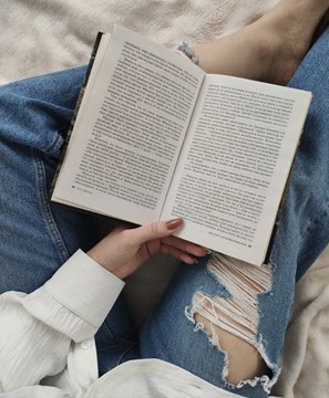 A woman partaking in the pastime of reading, as many people did much more over quarantine.