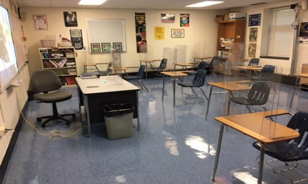 The picture above shows what the new “normal” is for a high school classroom following Covid-19 safety precautions. Plastic dividers and distanced seating restrict socialization in the classroom. 