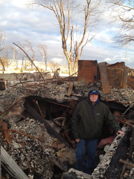 Former resident James Doyle standing in the remains of his house in Breezy Point just days after the storm. What was left of the kitchen can be seen behind him.