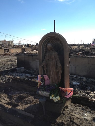 Mother Mary statue that survived the fire. Homemade cards and flowers placed at her feet.
