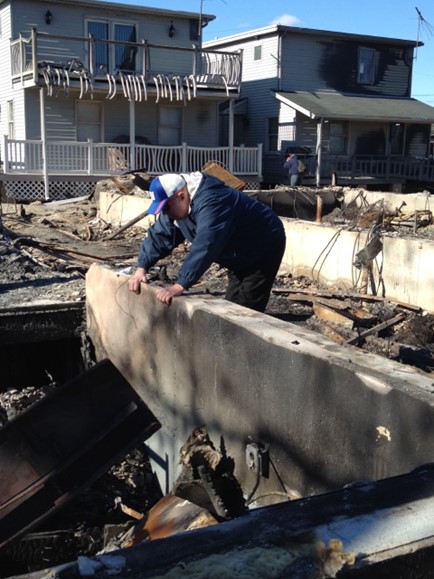 Former Resident James Doyle investigating the remains of his house in Breezy Point just days after the storm.