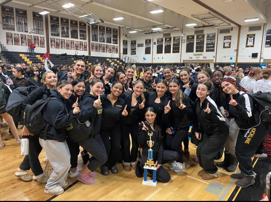Varsity+kickline+members+pose+with+a+trophy+at+a+recent+competition+-Courtesy+of+Alexis+Raynor