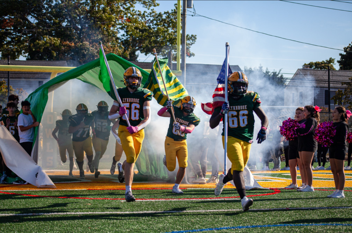 The Owls storm the field ahead of their win against Valley Stream North