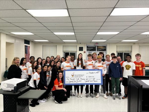 Members of Lynbrook soccer teams presenting the RMHC with check. Courtesy of the Lynbrook Soccer Booster Club