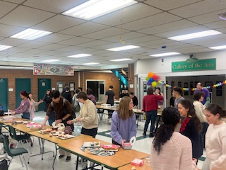 Students crowding the cupcake tables after school. 