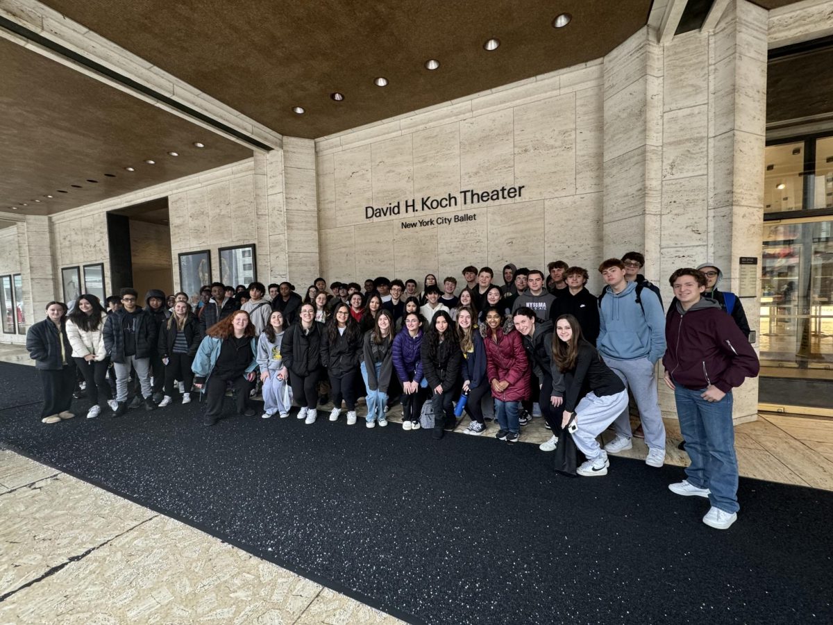 Band and orchestra students in front of the David H. Koch Center. 