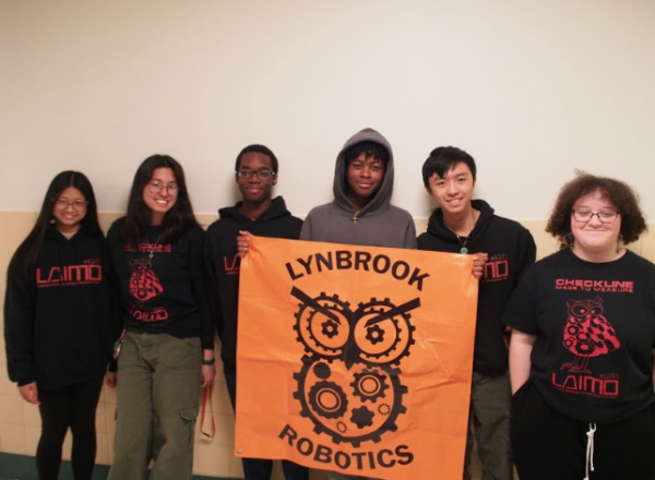 Robotics members wielding the club logo