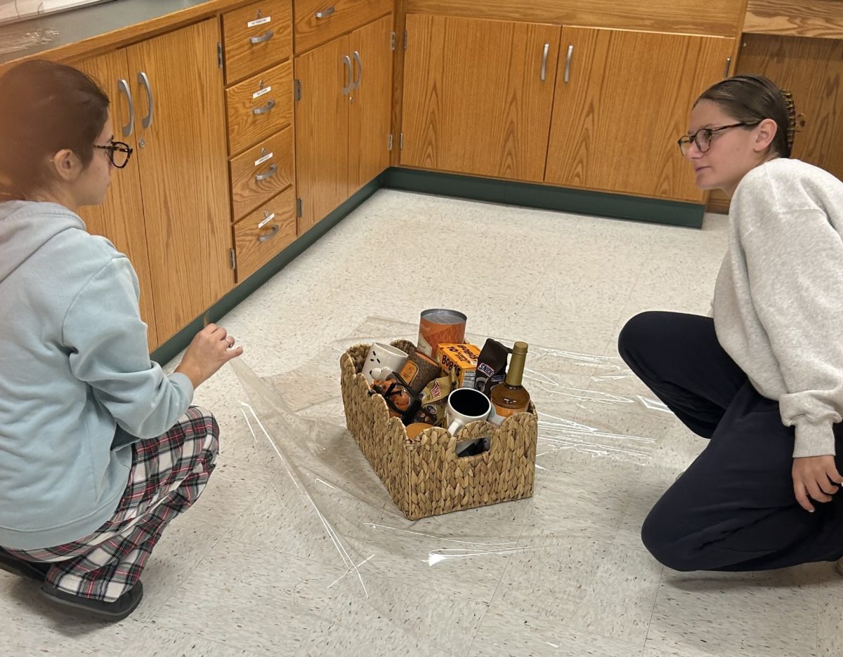 Students wrap raffle baskets in preparation for Night of the Pumpkins