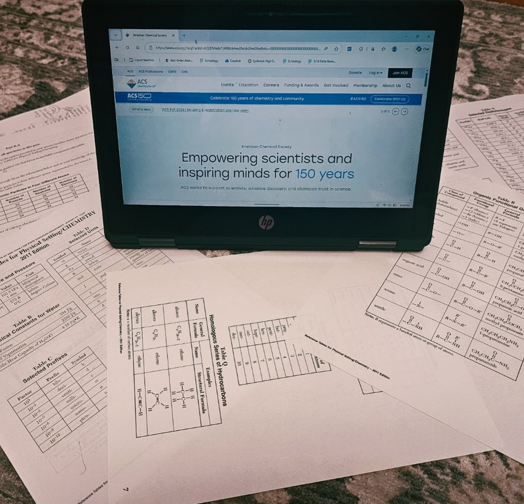 Pictured is a computer surrounded by pages associated with high school-level chemistry. On the computer is the American Chemical Society website. This website is what influenced the development of this club. This website is what helped Constanzo and Delgado to come up with ideas for future events, and labs to do next year for the club. 
