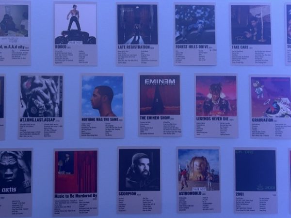 Album covers displayed on a wall. Listening to albums can be a great way to connect with other people through music. Just like watching movies with others, listening to an album can be a unique bonding experience that helps people connect through shared enjoyment of the music. 